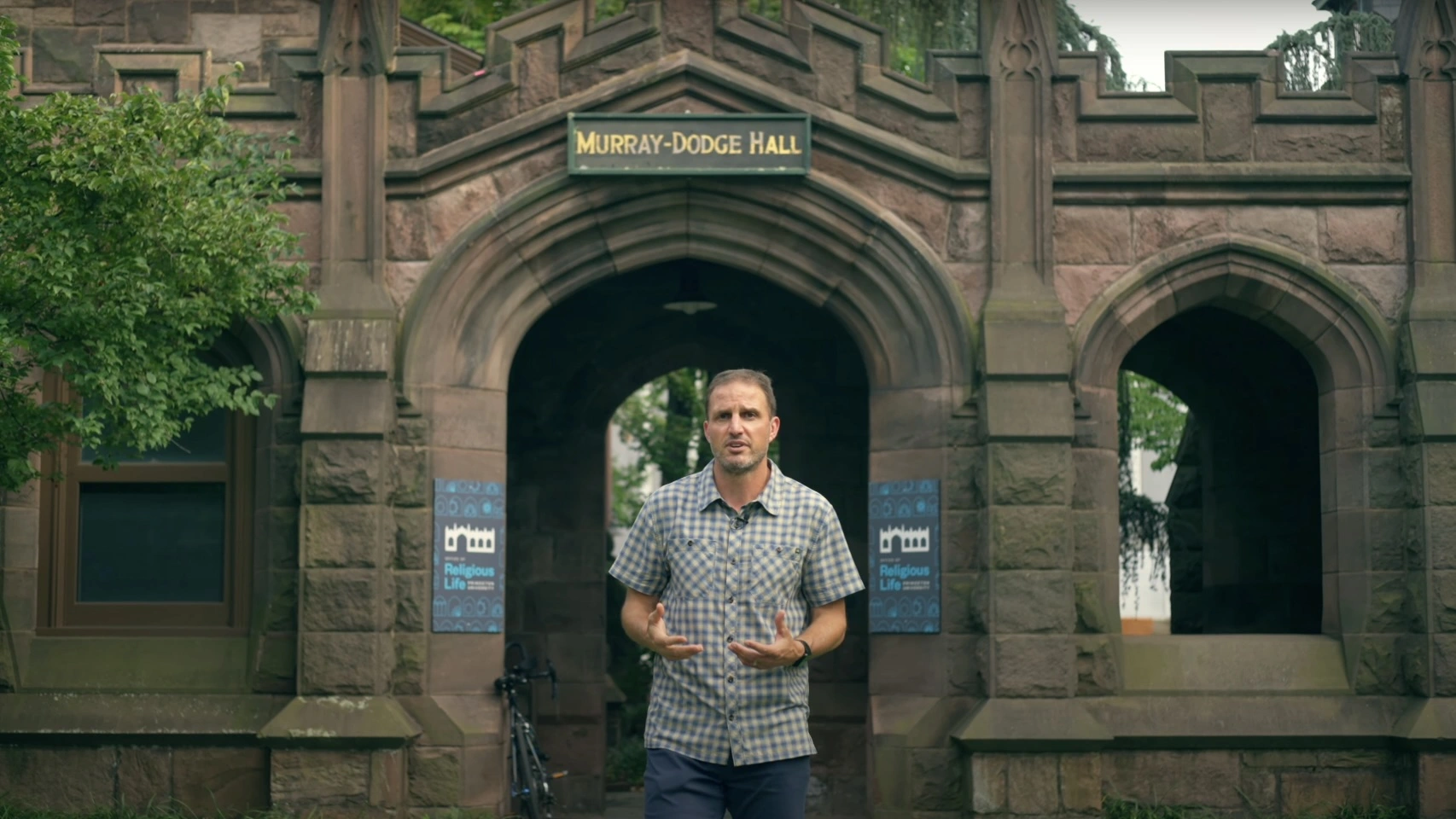 Man in front of Murray-Doge Hall on Princeton University campus